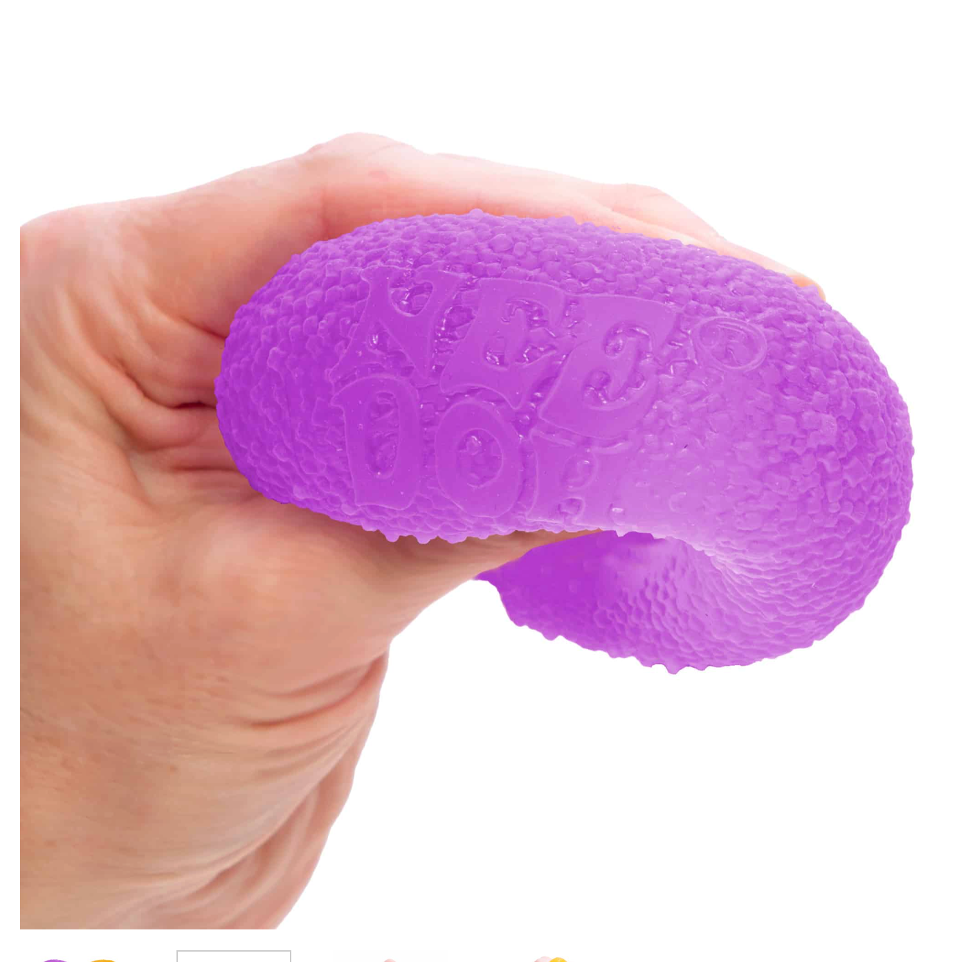 hand squeezing NeeDoh Gumdrop stress relief fidget toy demonstrating textured sensory experience