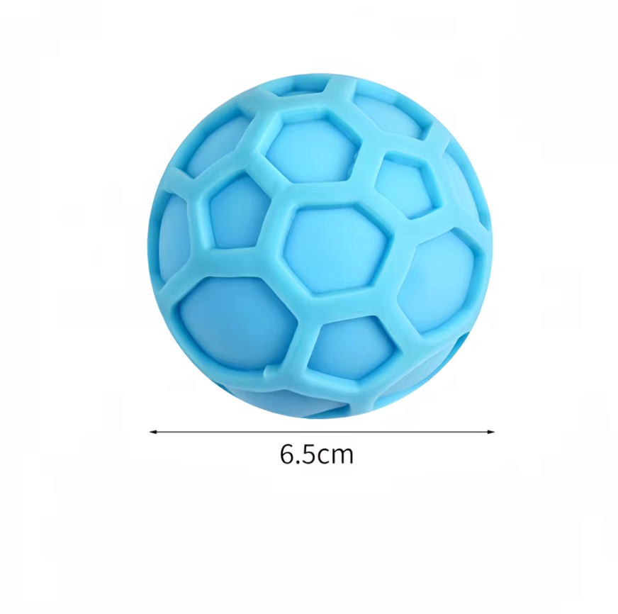 Hand squeezing NeeDoh Atomic fidget toy showing one ball splitting into multiple connected groovy globs for sensory stress relief