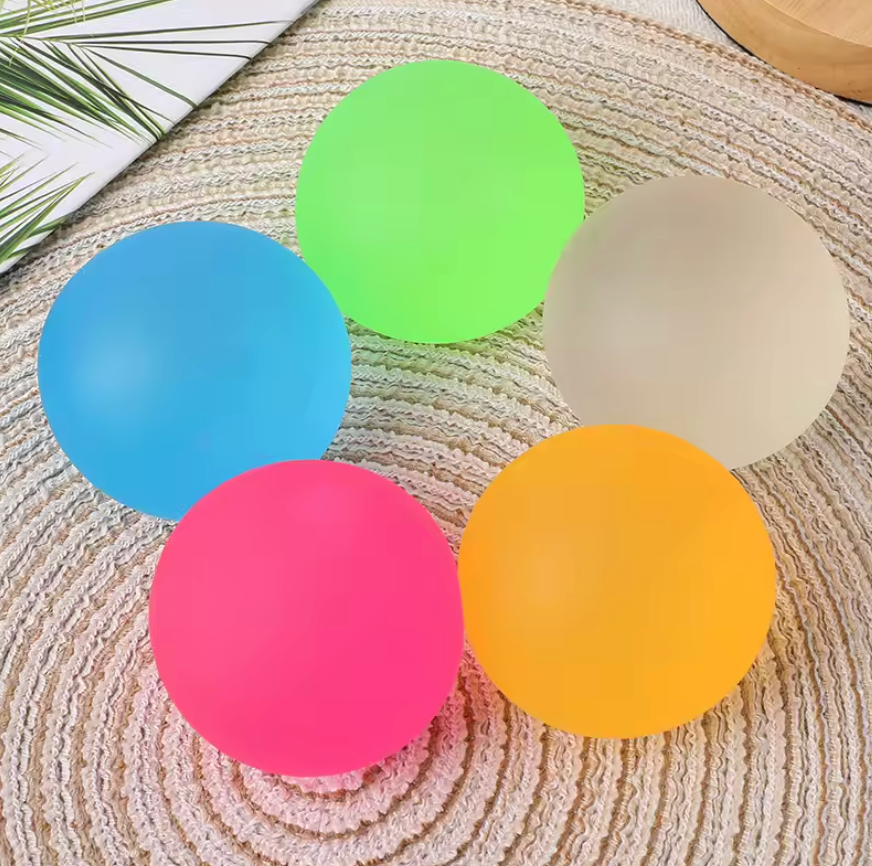 NeeDoh Super Groovy Glob jumbo dough-filled sensory squeeze stress ball in assorted colors on white background
